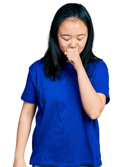 Young chinese woman wearing casual blue t shirt feeling unwell and coughing as symptom for cold or bronchitis. health care concept.