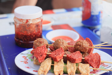 Close up of khmer meat skewers with chrouk metae or chili paste, a popular street food in Cambodia