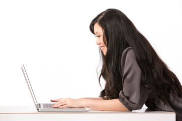 Happy Asian woman using her laptop.