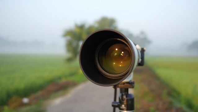 A 200-600mm zoom lens with camera on stand ready for shooting. This versatile lens is perfect for wildlife, sports, travel, nature, and landscape photography