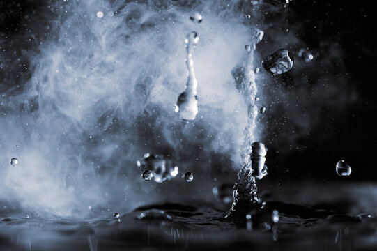 Boiling Water Splash With Steam On Black Background Closeup