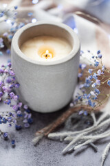 Candle and a branch of gypsophila flowers