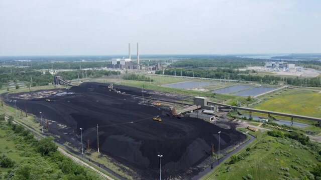 Grader working a pile of coal for the DTE Belle River Power Plant, in East China, Michigan, USA.