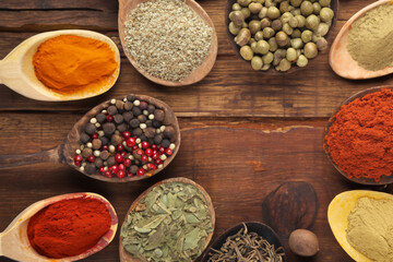 Spices and herbs in wooden bowls. Food and cuisine ingredients.