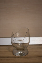 Broken transparent drinking glass in the kitchen
