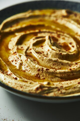 Turkish hummus close up. Creamy dip made from chickpeas, tahini, olive oil, lemon juice, and garlic. Include yogurt or butter for extra richness. 