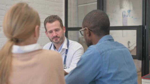 Close up of Interracial Couple Discussing Health Issues with Doctor