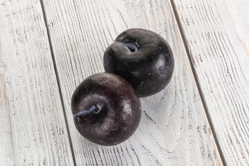 Two ripe sweet black plums