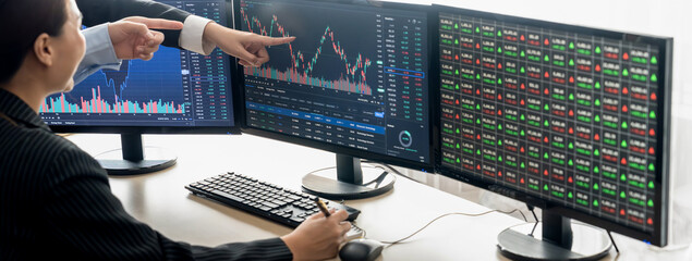 A cropped image of cooperate skilled business team discussion about stock investment while point...