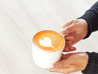 person holding a cup of tea