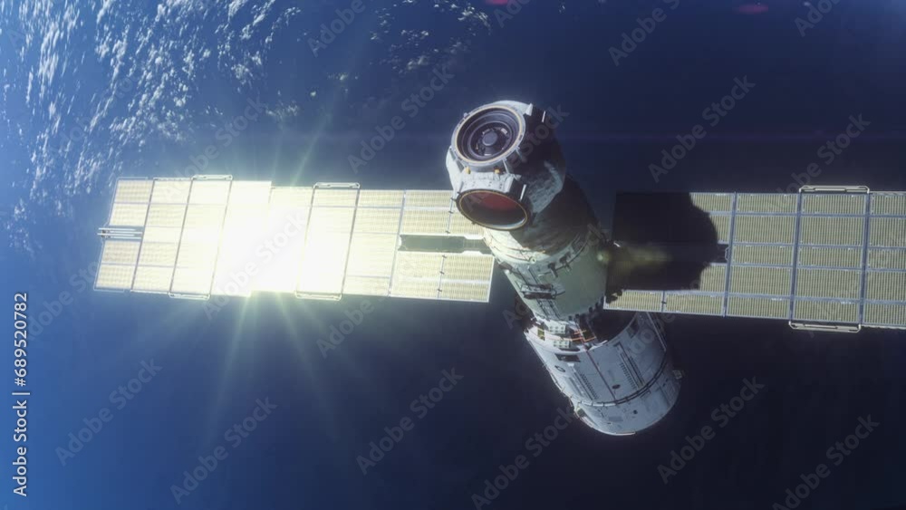 Wall mural the space module is flying in space in the orbit of the planet