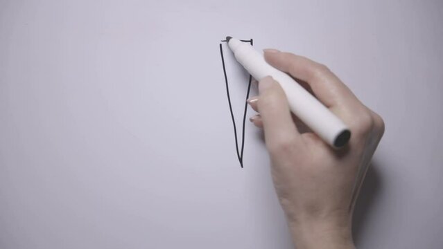 ! girl draws an exclamation mark with a black marker on a white board