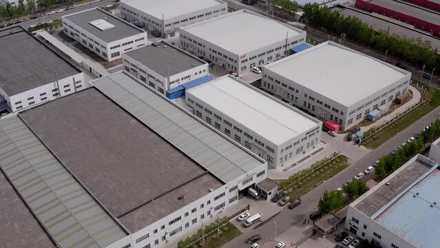 Chinese industrial zone with factory buildings and warehouses. This is a 4K cinematic drone footage.
