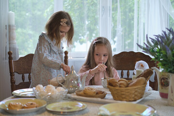 English tea with a rustic twist: Little sisters savoring the essence of tradition in a serene countryside environment