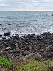 This is a beach in Jeju with basalt rocks.