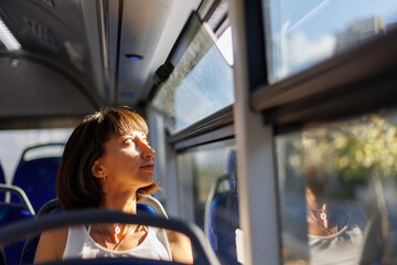 young woman sitting on a public bus.