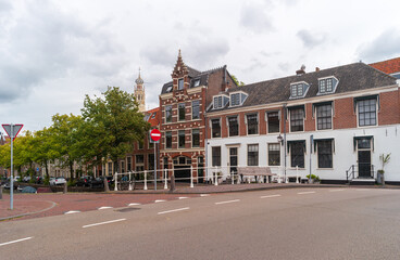 View of quiet street with Dutch residential building along the canal in Haarlem, Netherlands.