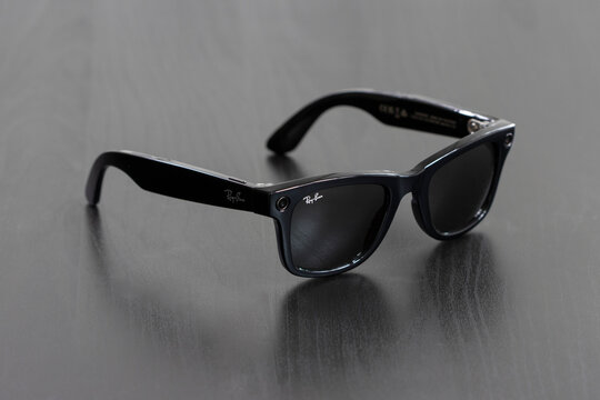 Portland, OR, USA - Dec 5, 2023: A pair of new Ray-Ban Meta Wayfarer smart glasses isolated on a dark gray background.