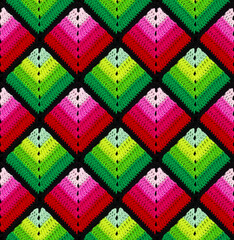 Seamless knitted pattern in the form of gradient rhombuses is crocheted with multi-colored threads. Patchwork style. Acrylic blanket.