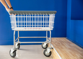 Laundry and housework. Woman hands holding empty new white trolley cart, metal cart parked use for laundry at convenience store for support customer, Laundromat convenience store concept - Powered by Adobe