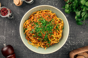 Portion of appetizing spaghetti bolognese with herbs