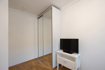 Small tv on a tv stand in rental apartment