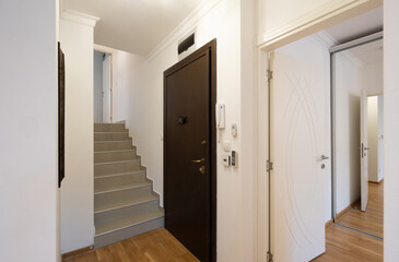 Entrance corridor with doors in apartment building