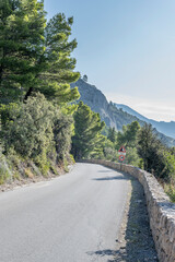 mountain road on steep slope at Mediterranean shore, Monte Argentario, Italy