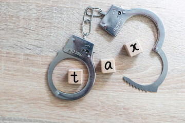 TAX stamp and handcuffs. Crime and punishment related conceptual 3D rendering