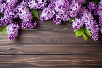 Beautiful bright lilac flowers on wooden background, closeup