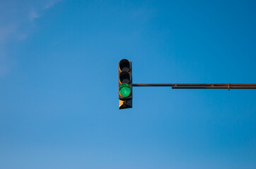 Traffic light showing red with blue sky background