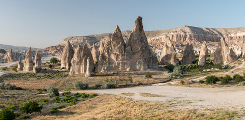 panoramic view of unique volcanic landscapes with fairy chimneys at Rose Valley, Cappadocia, Turkey
