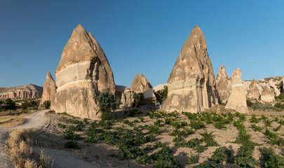 farming land in Rose Valley with the spectacular rock formation in the background, Cappadocia, Turkey