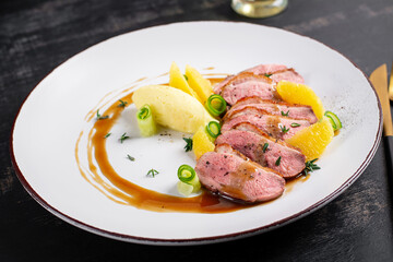 Traditional gourmet duck breast fillet with mashed potatoes and orange sauce.