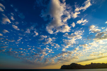 Real amazing panoramic sunrise or sunset sky with gentle colorful clouds.