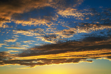 Real amazing panoramic sunrise or sunset sky with gentle colorful clouds.