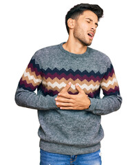 Young handsome man wearing casual winter sweater with hand on stomach because nausea, painful...