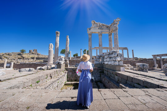 Asian woman tourist Standing and asking for blessing from god according to belief in Altar of Zeus, Temple of Trajan Acropolis of Pergamon Ancient Greek City Landmark of Tourism Turkiye, Izmir, Turkey