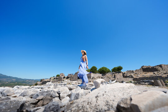 Lifestyle, Asian woman tourist take a holiday for travel in summer at Acropolis of Pergamon Ancient Greek City, Landmark of Tourism Turkiye, Izmir, Turkey. She is stand wind and enjoy relax vacation..