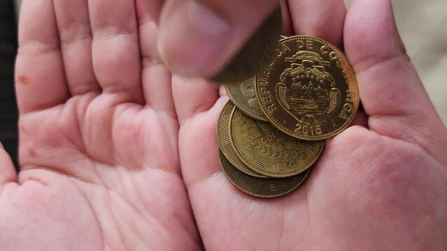 Costa Rican colones being counted 