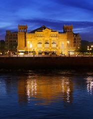 Fototapeta na wymiar Victoria Eugenia Theater. The Victoria Eugenia Theater illuminated at dusk is located in the city of Donostia San Sebastian, Euskadi.