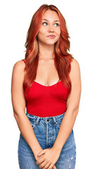 Young redhead woman wearing casual clothes smiling looking to the side and staring away thinking.