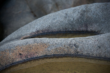 Large stones with indentations close-up with water, wallpaper