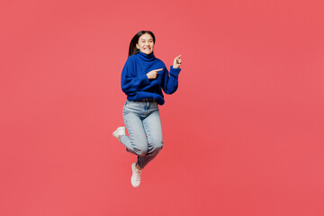 Full body young woman of Asian ethnicity wear blue sweater casual clothes jump high point index...