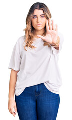 Young caucasian woman wearing casual clothes doing stop sing with palm of the hand. warning expression with negative and serious gesture on the face.