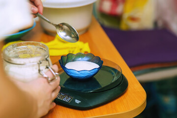 Weighing Sugar on a Kitchen Scale for Cooking