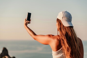 Selfie woman in cap and tank top making selfie shot mobile phone post photo social network outdoors...