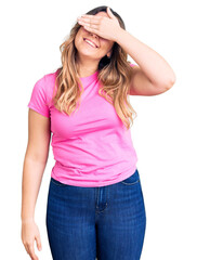 Fototapeta premium Young caucasian woman wearing sportswear smiling and laughing with hand on face covering eyes for surprise. blind concept.