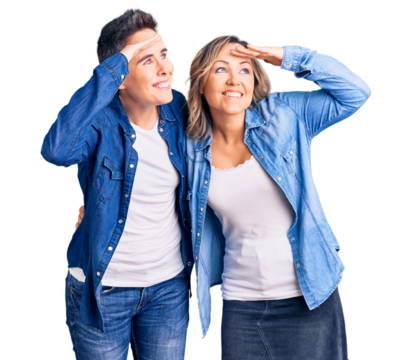 Couple of women wearing casual clothes very happy and smiling looking far away with hand over head. searching concept.