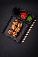 Delicious warm sushi roll with tuna, salmon, shrimp, cucumber and cream cheese